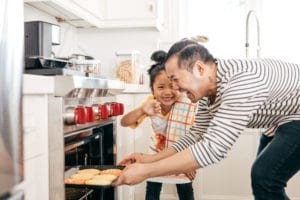 Father and daughter making cookies.